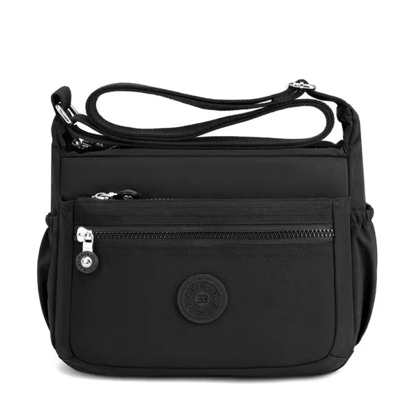 Lightweight nylon crossbody bag in Black – water-resistant, 4 zip sections and wide adjustable strap