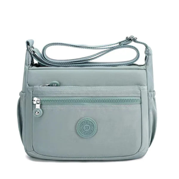 Lightweight nylon crossbody bag in Light Green – water-resistant, 4 zip sections and wide adjustable strap