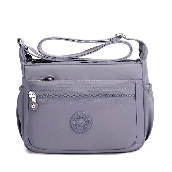 Lightweight nylon crossbody bag in Grey – water-resistant, 4 zip sections and wide adjustable strap
