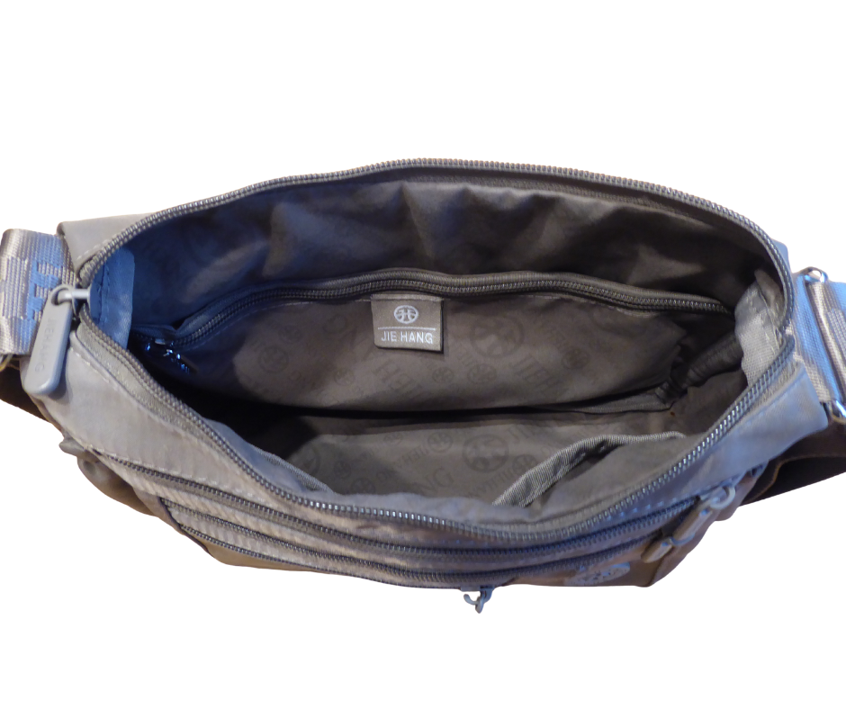 Inside of nylon crossbody bag – showing 2 internal zip sections and open pouch pockets