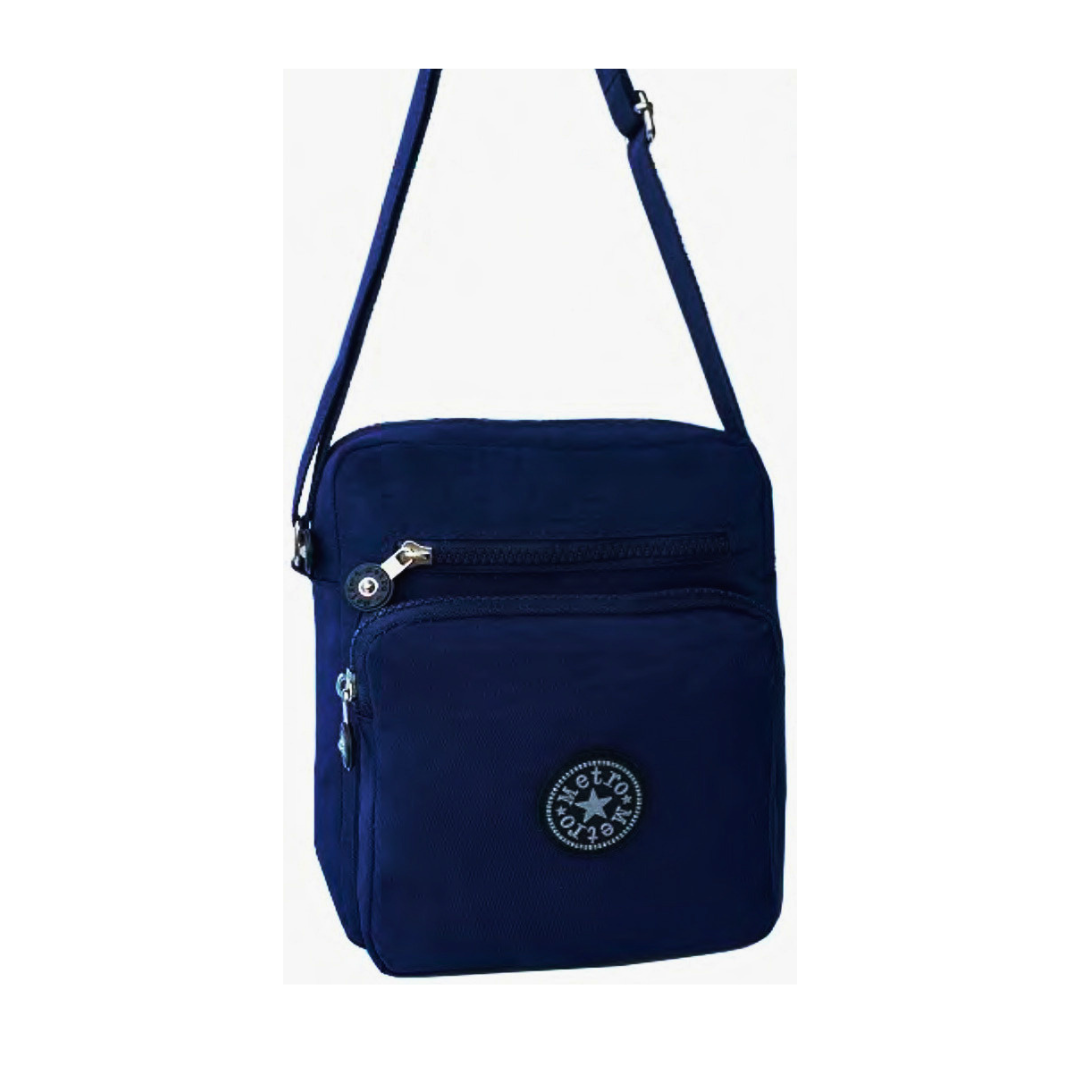 A small crossbody bag in navy, featuring a front zippered pocket with a  logo badge, a top zippered compartment, and a matching shoulder strap, shown against a plain white background.