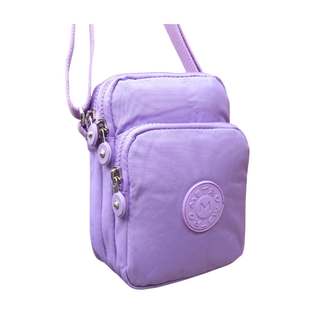 A light purple nylon crossbody phone bag with a front zippered pocket, silver zipper pulls, and a circular embossed logo on the front pocket, shown on a plain white background.