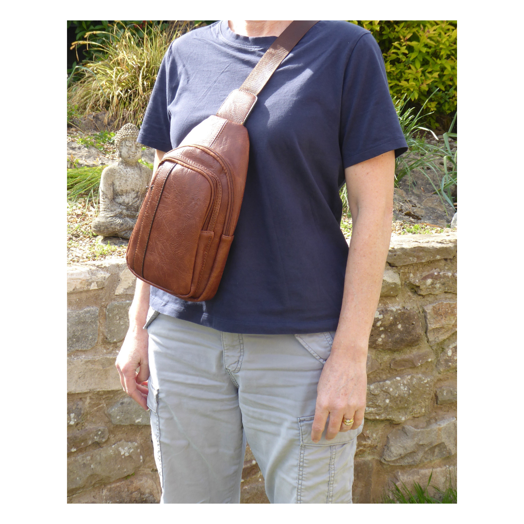 Crossbody sling bag — open showing interior pockets