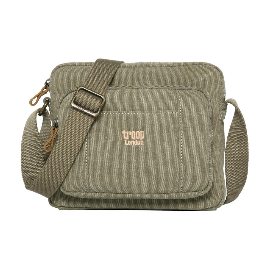 Khaki green canvas crossbody bag with a front pocket featuring the 'troop london' logo in a light tan color, shown on a plain white background.